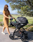 Mimi LUNO 3-in-1 Travel System shown outdoors with AVARO infant car seat attached