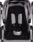 Gray and black stroller with a baby seat on a white background