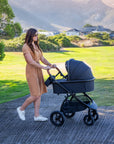 Mimi LUNO 2-in-1 Travel System shown outdoors with carrycot attached