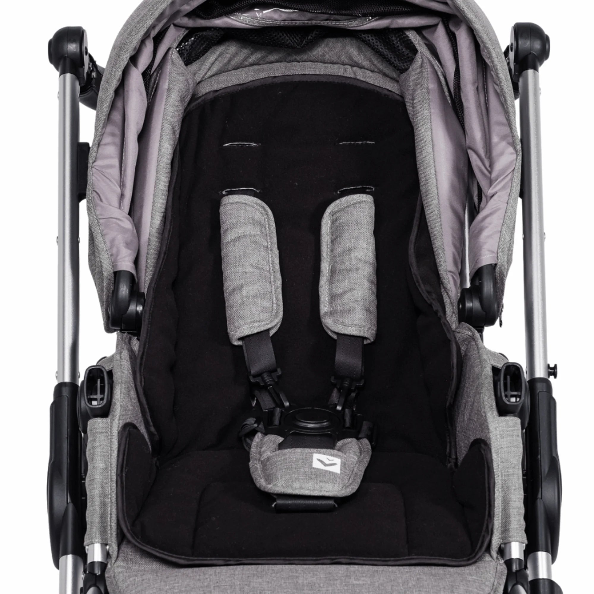 Mimi Universal Stroller Insert fitted in a stroller seat with harness openings visible